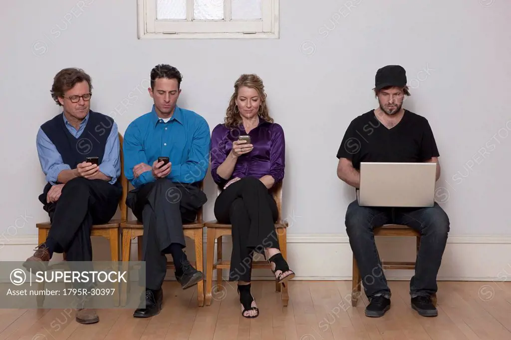 Four people sitting in a row