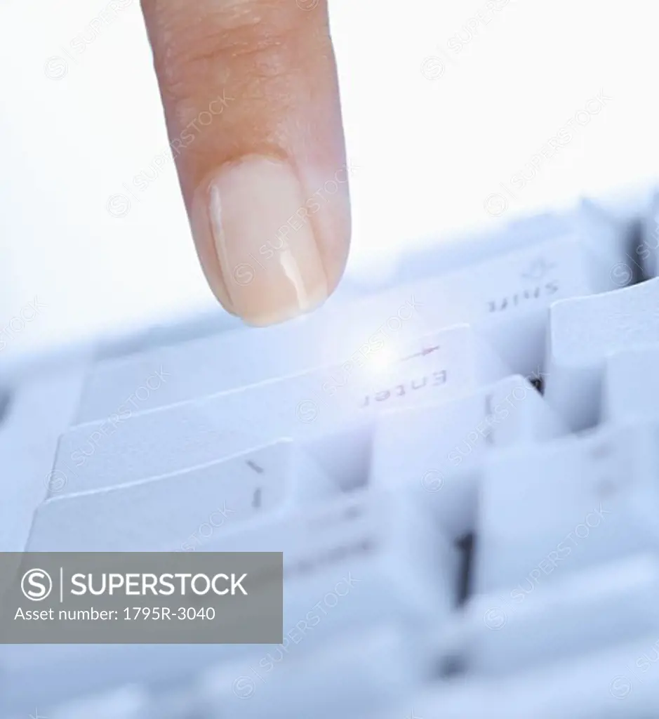 Finger pushing enter key on computer