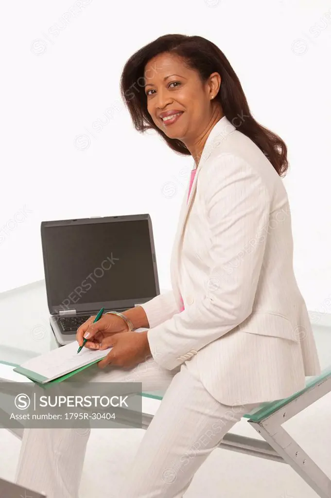 Businesswoman sitting on desk