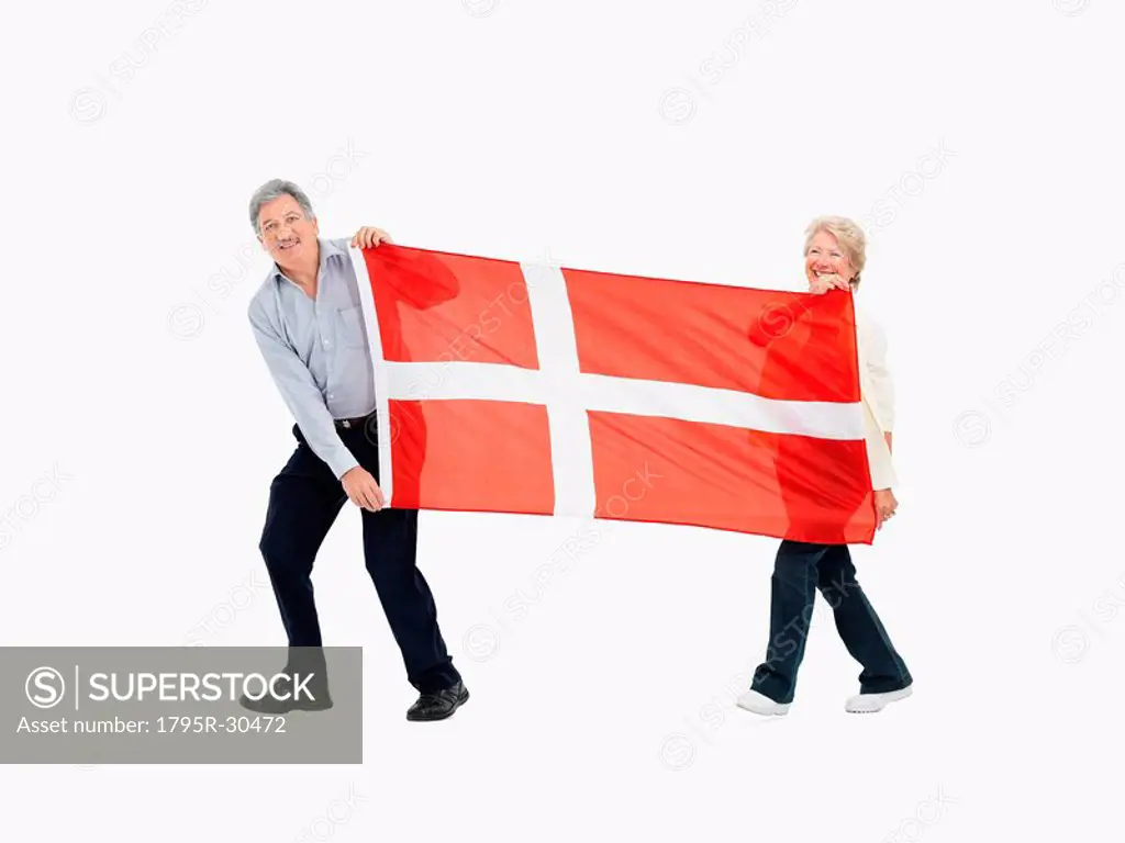 Two people carry the Danish flag