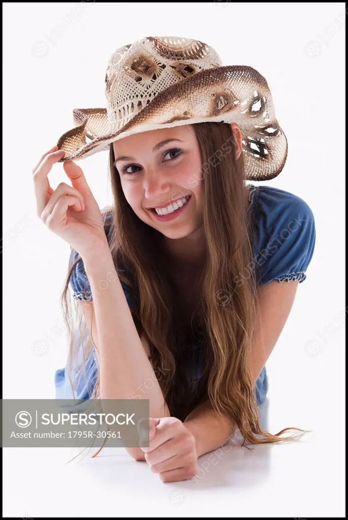 Beautiful cowgirl tipping her hat