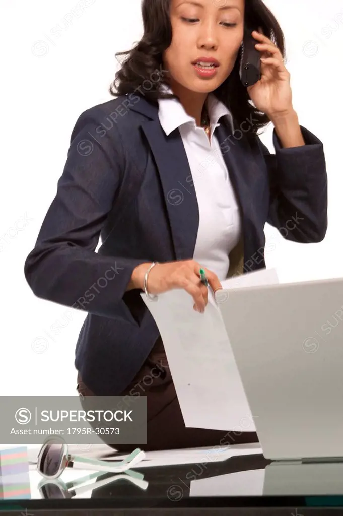 Businesswoman sitting on desk