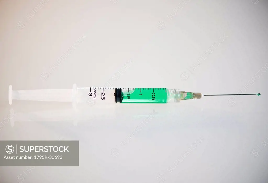 Syringe filled with green liquid