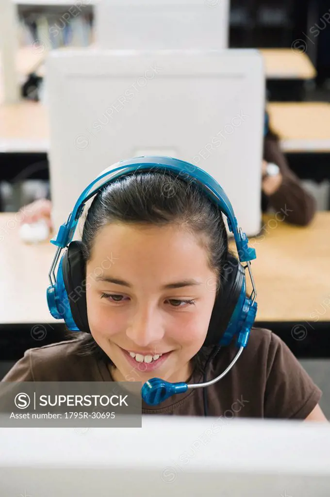 Elementary student wearing headphones in classroom