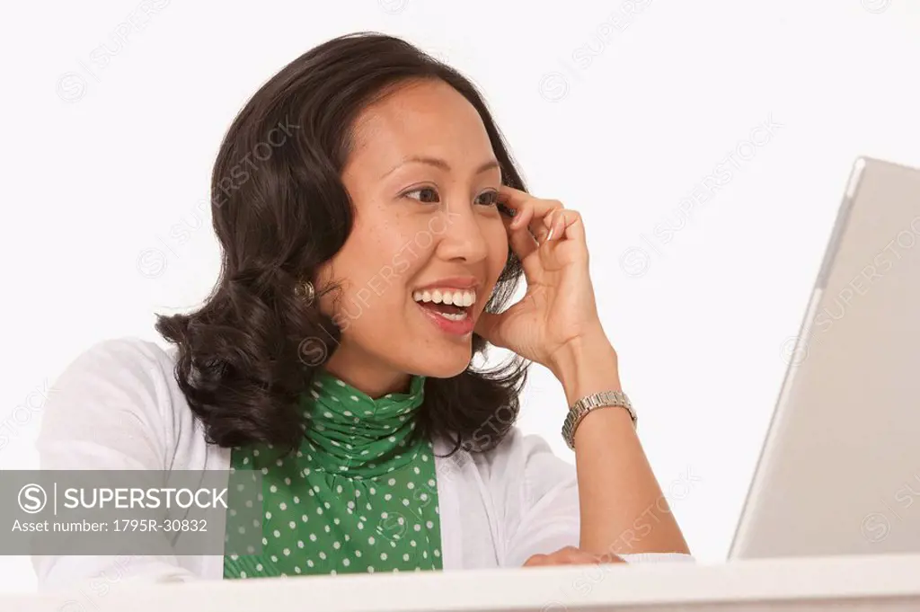 Happy woman looking at laptop