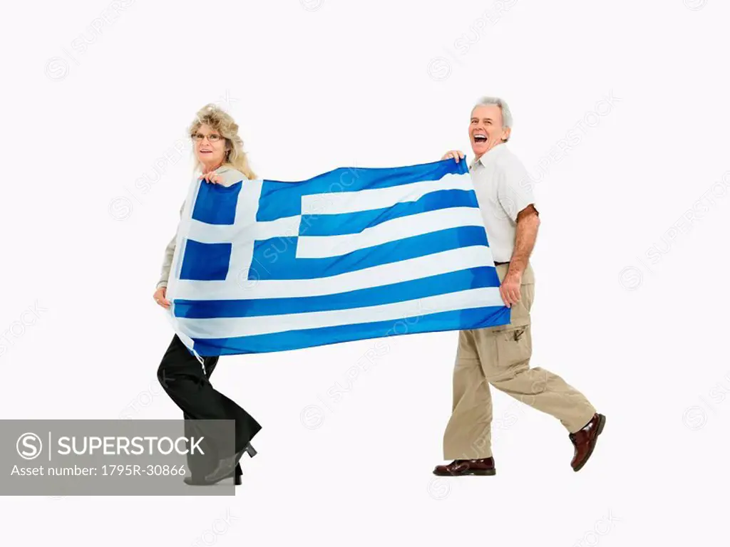 Two people carrying the Greece flag