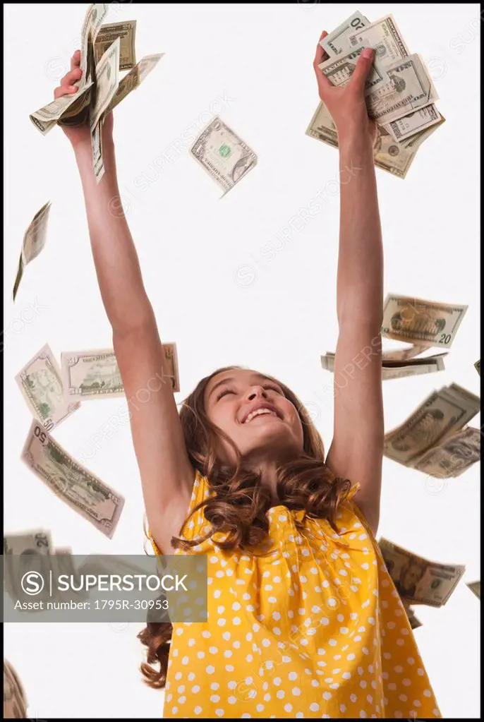 Young girl throwing money in the air