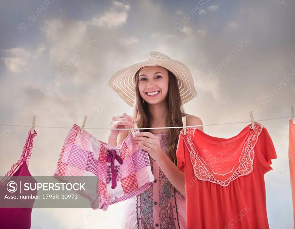 Woman hanging laundry on clothesline