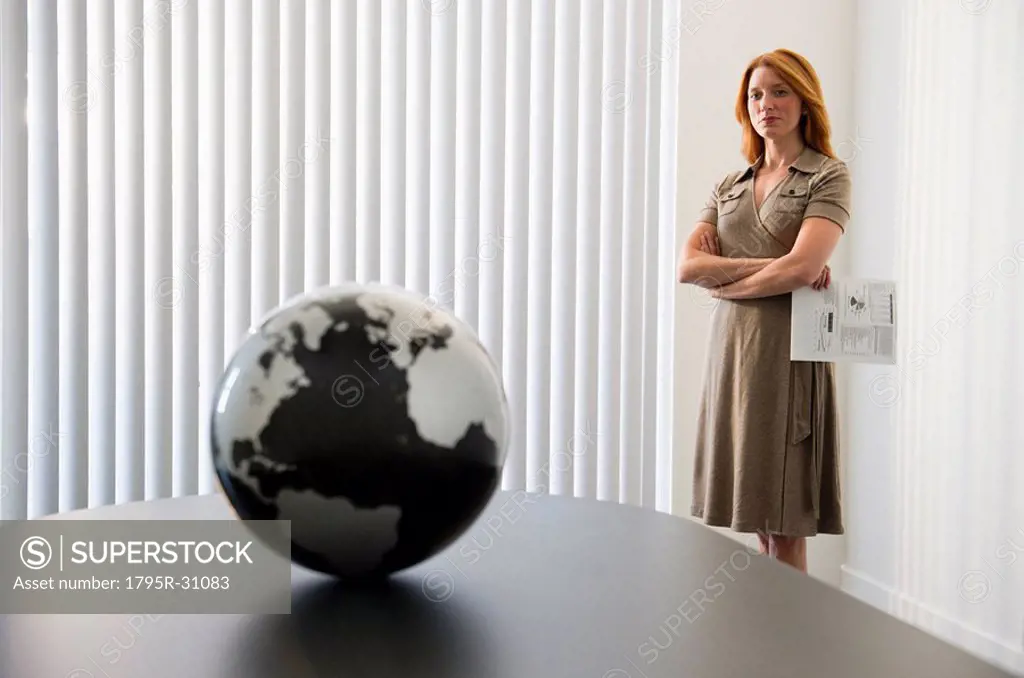 Businesswoman looking at globe