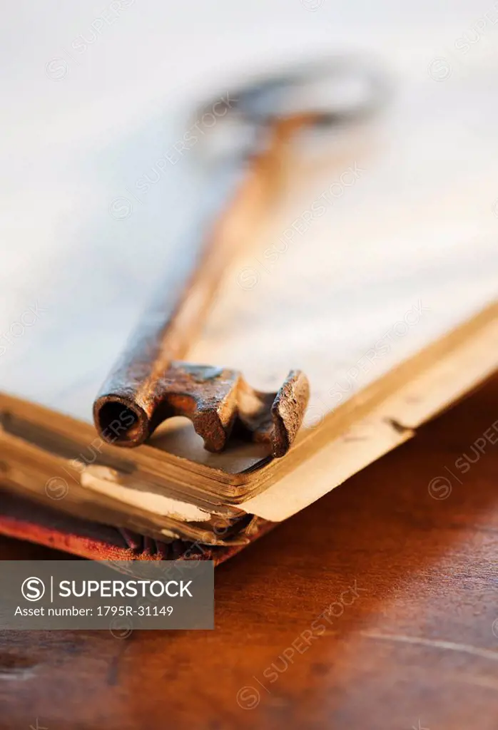 Antique key on top of book