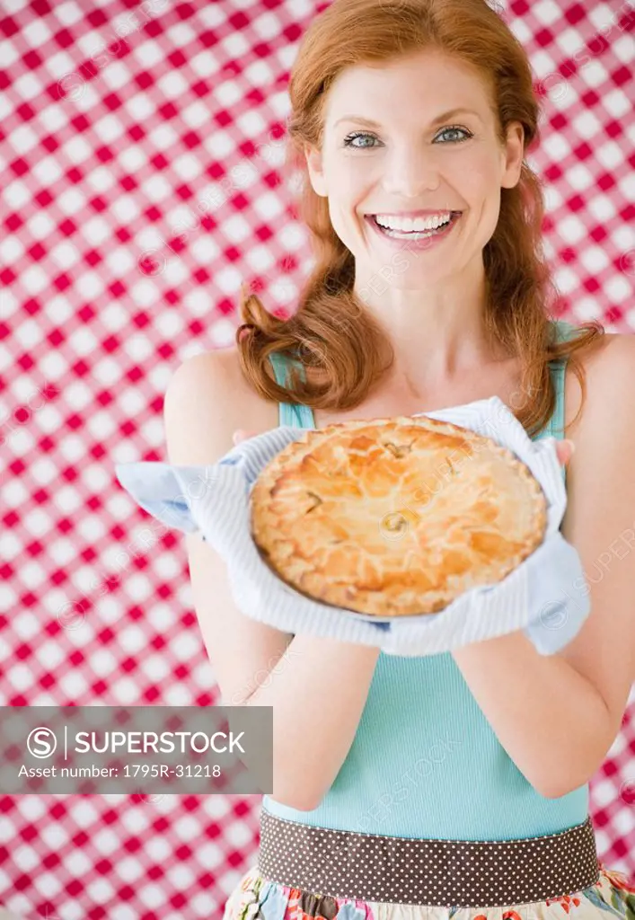 Woman holding a freshly baked pie