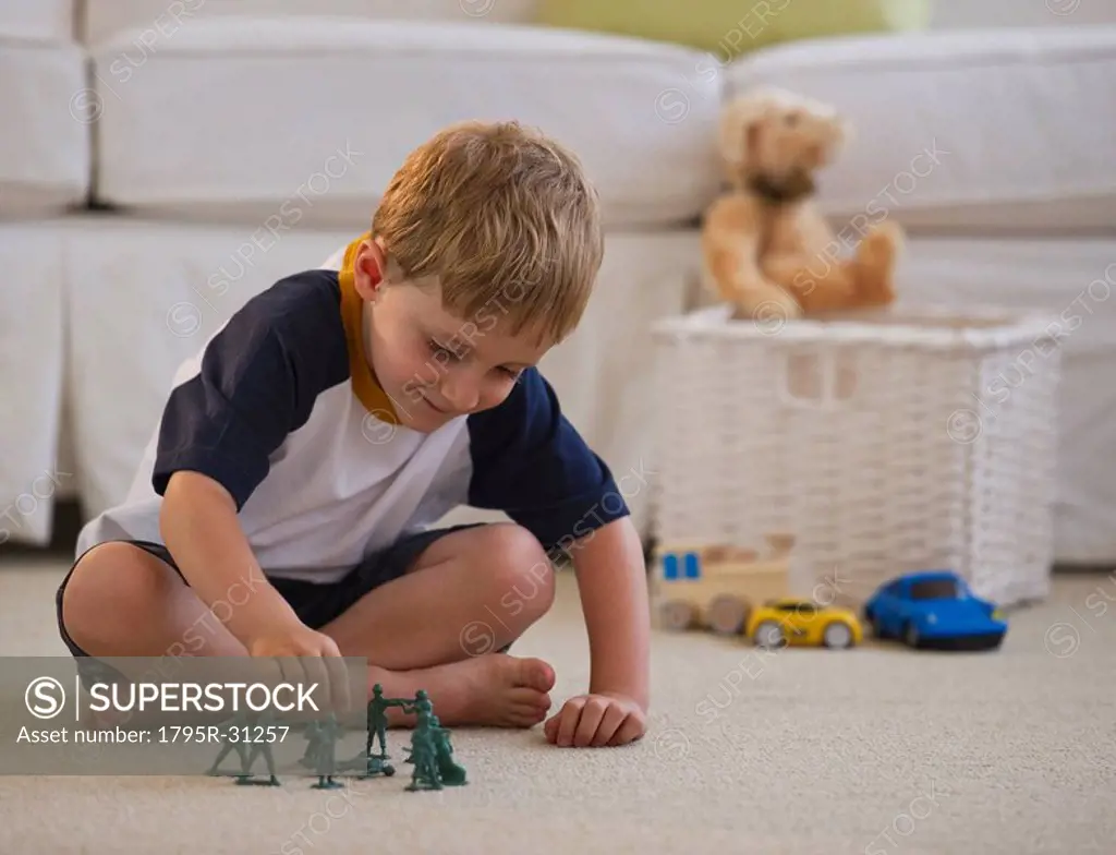 Young boy playing with toy soldiers
