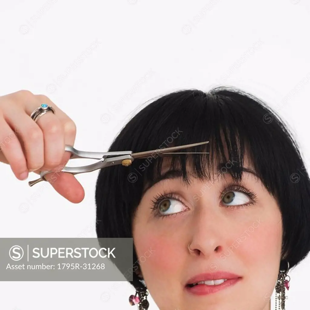 Nervous woman watching her hair being cut