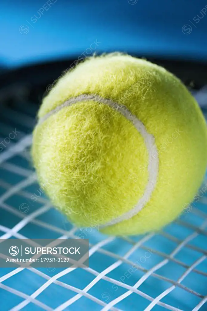 Closeup of tennis racquet and ball