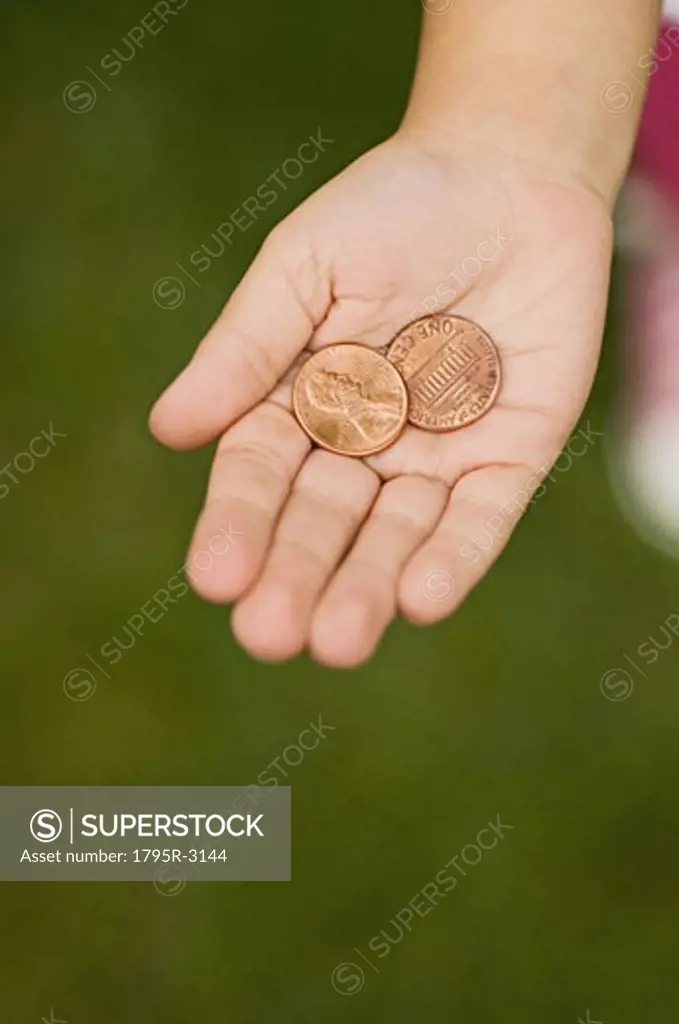 Closeup of pennies in childs palm