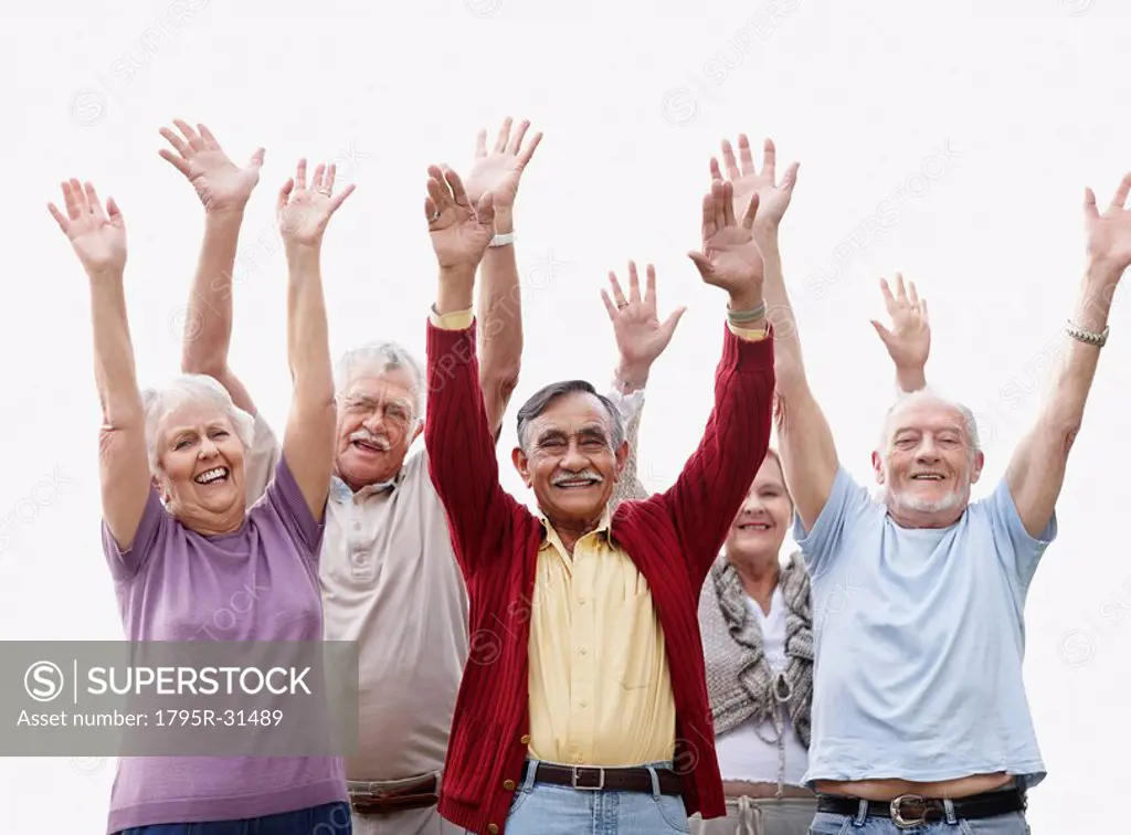 Group of senior with their arms raised