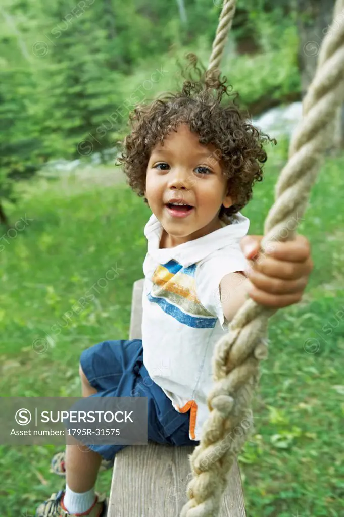 Cute young child sitting on swing