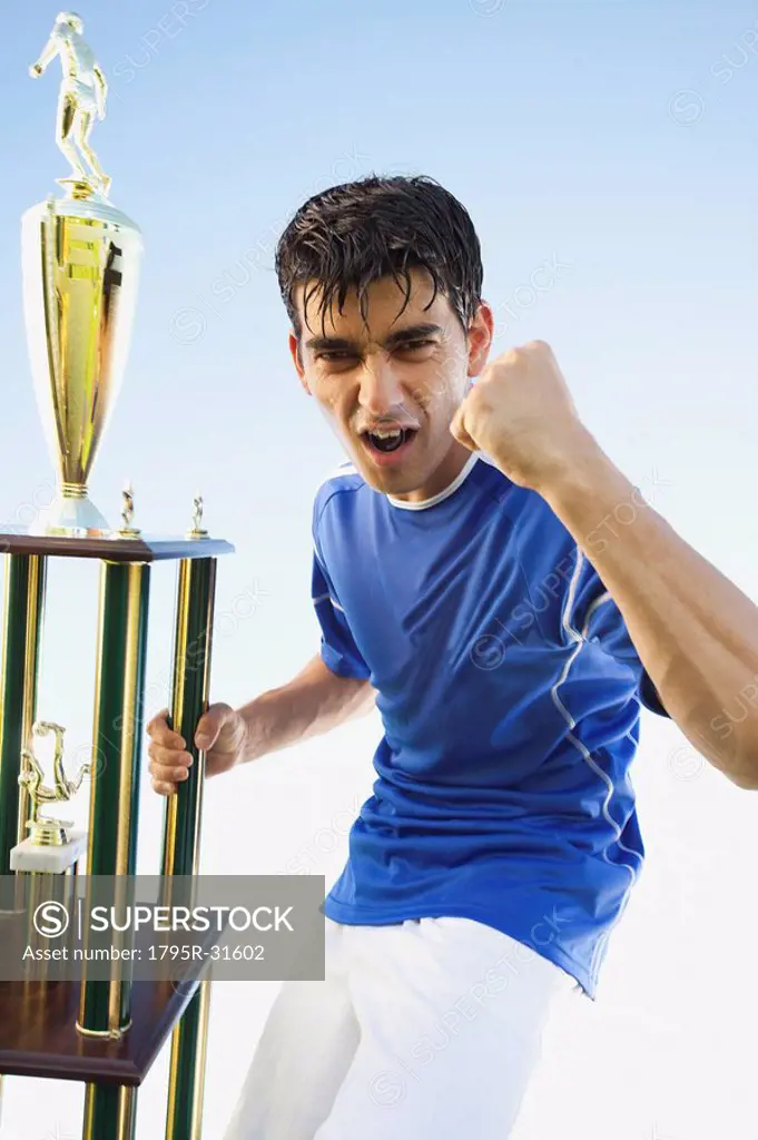 Football player holding trophy