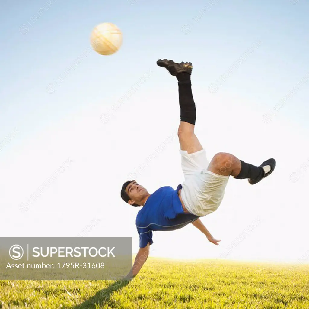Soccer player jump kicking