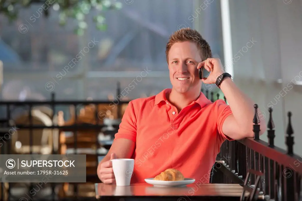 Man sitting on patio at cafe