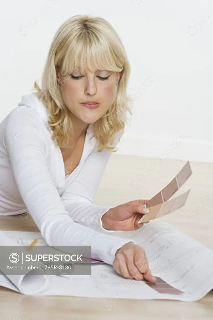 Woman with color samples and blueprints