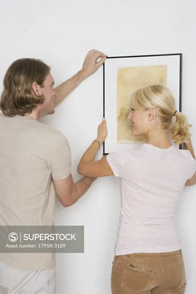 Couple hanging pictures