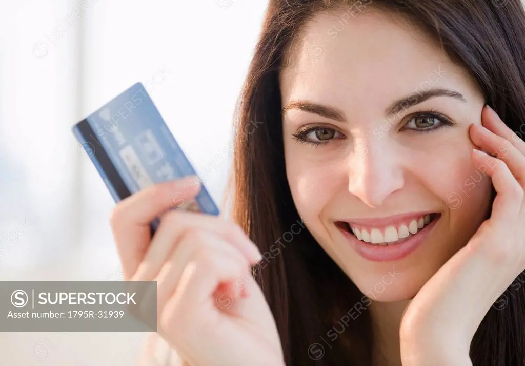 Young woman holding a credit card