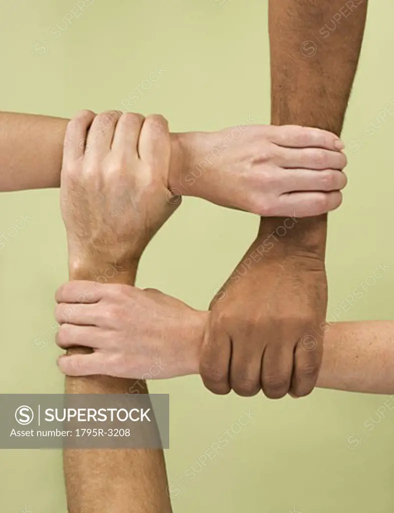 Hands holding arms in multiracial group