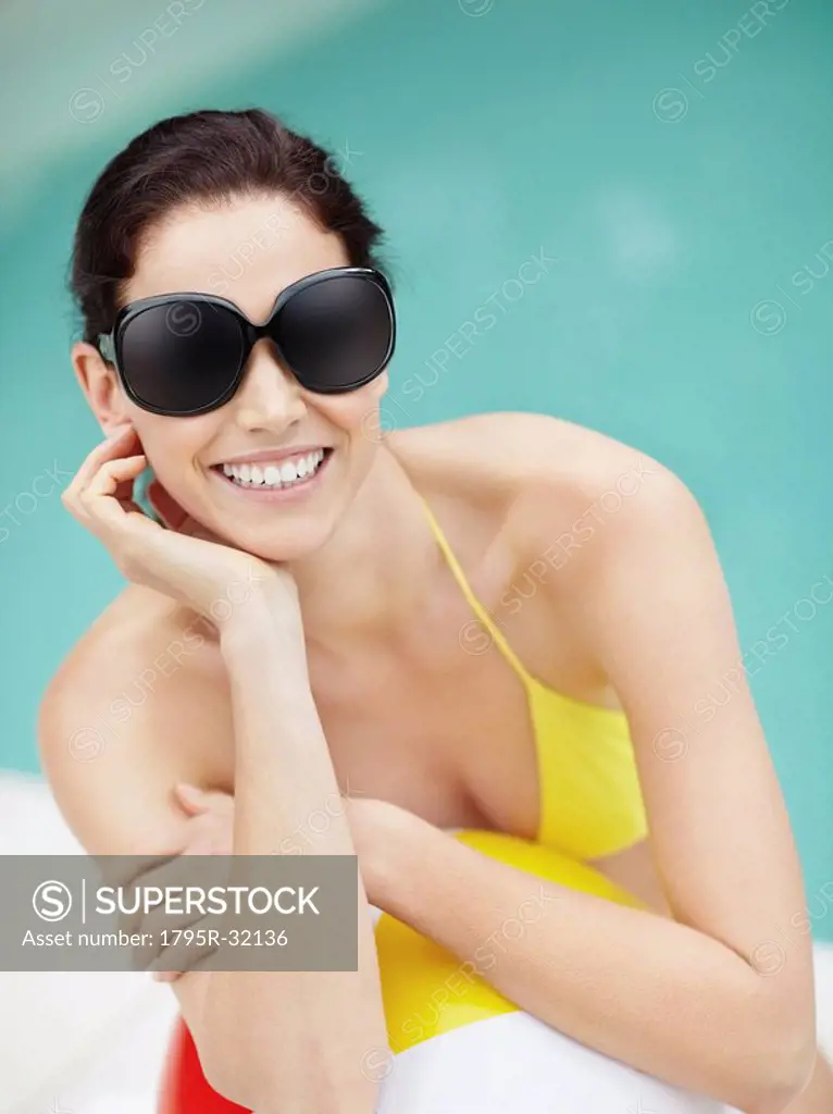 Attractive brunette wearing sunglasses and bikini