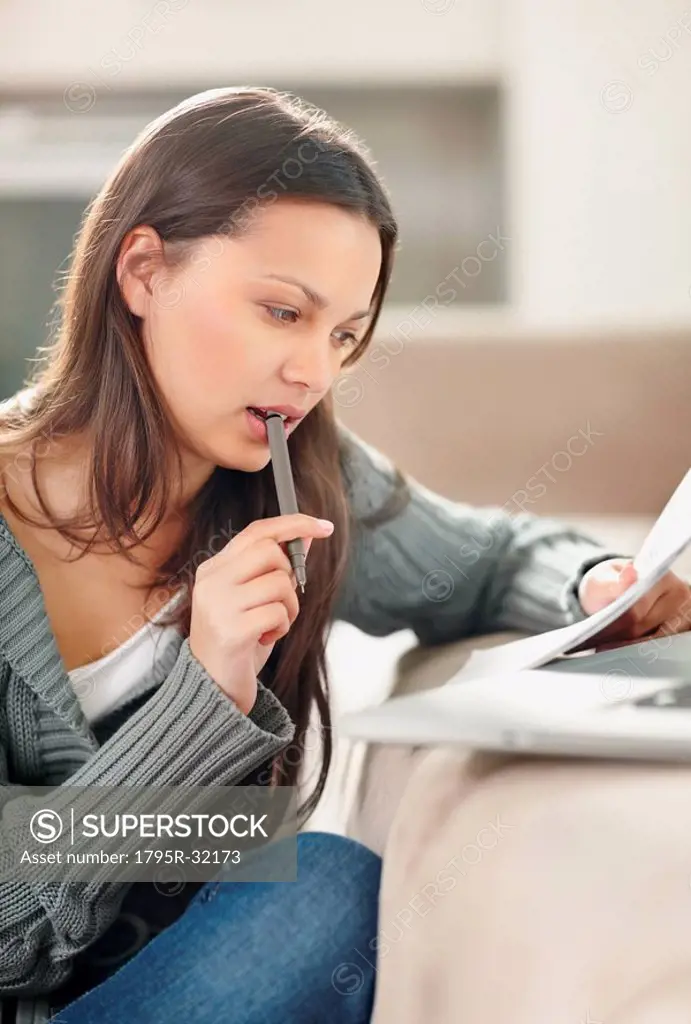 Woman concentrating while doing paperwork