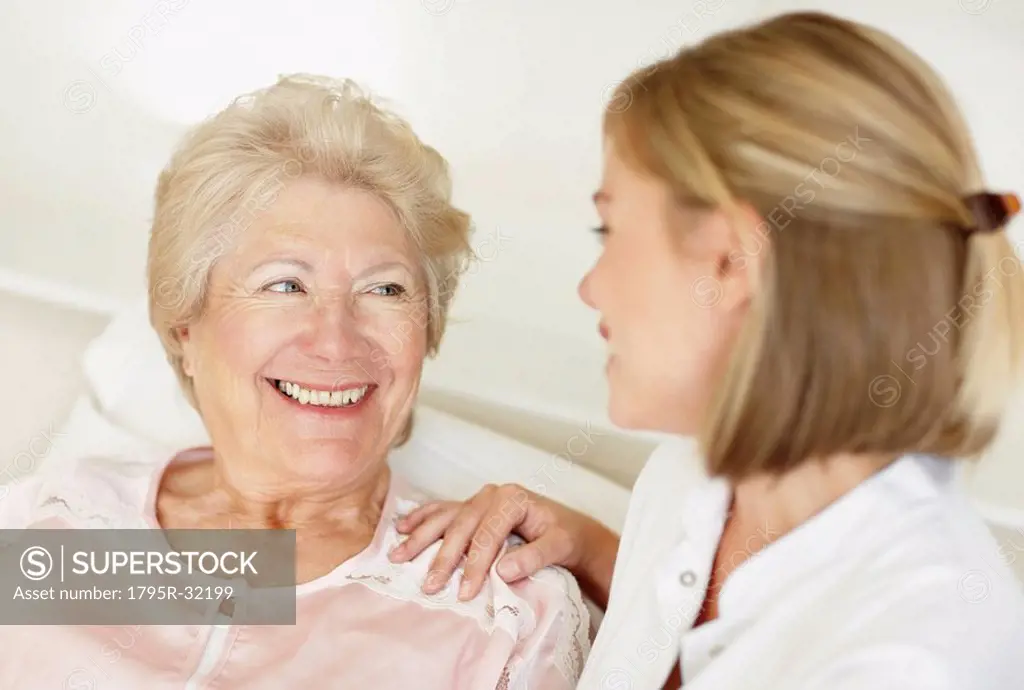 Nurse sitting with a senior woman