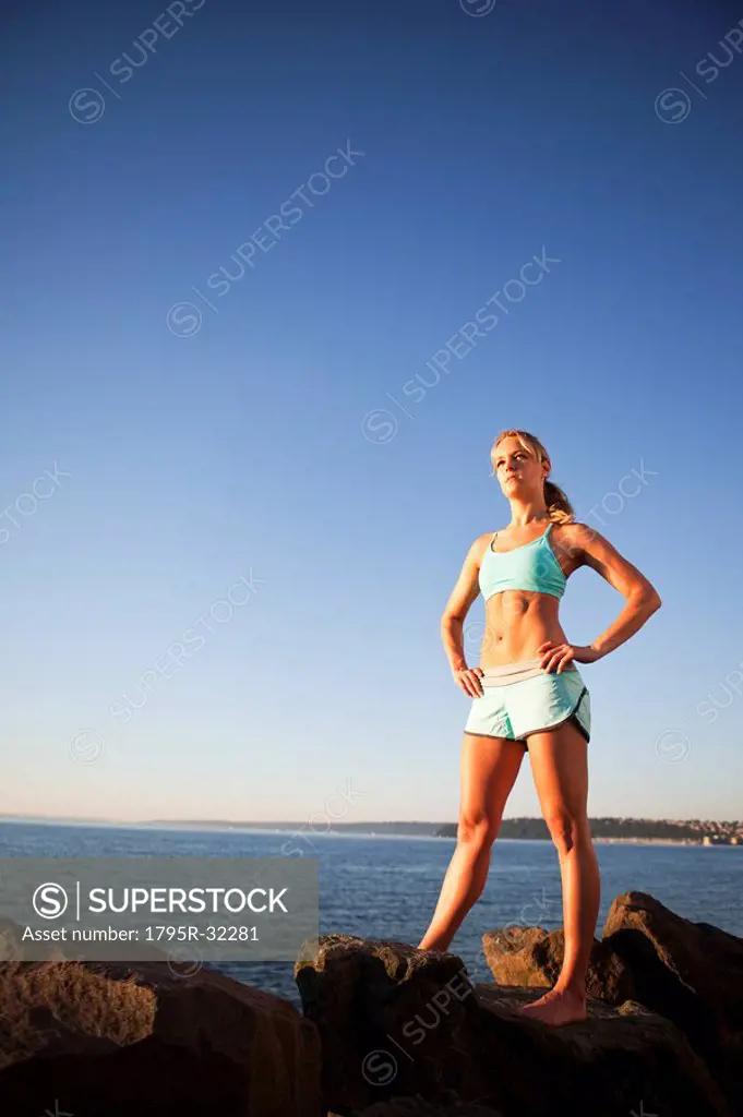 Athletic woman standing by the ocean