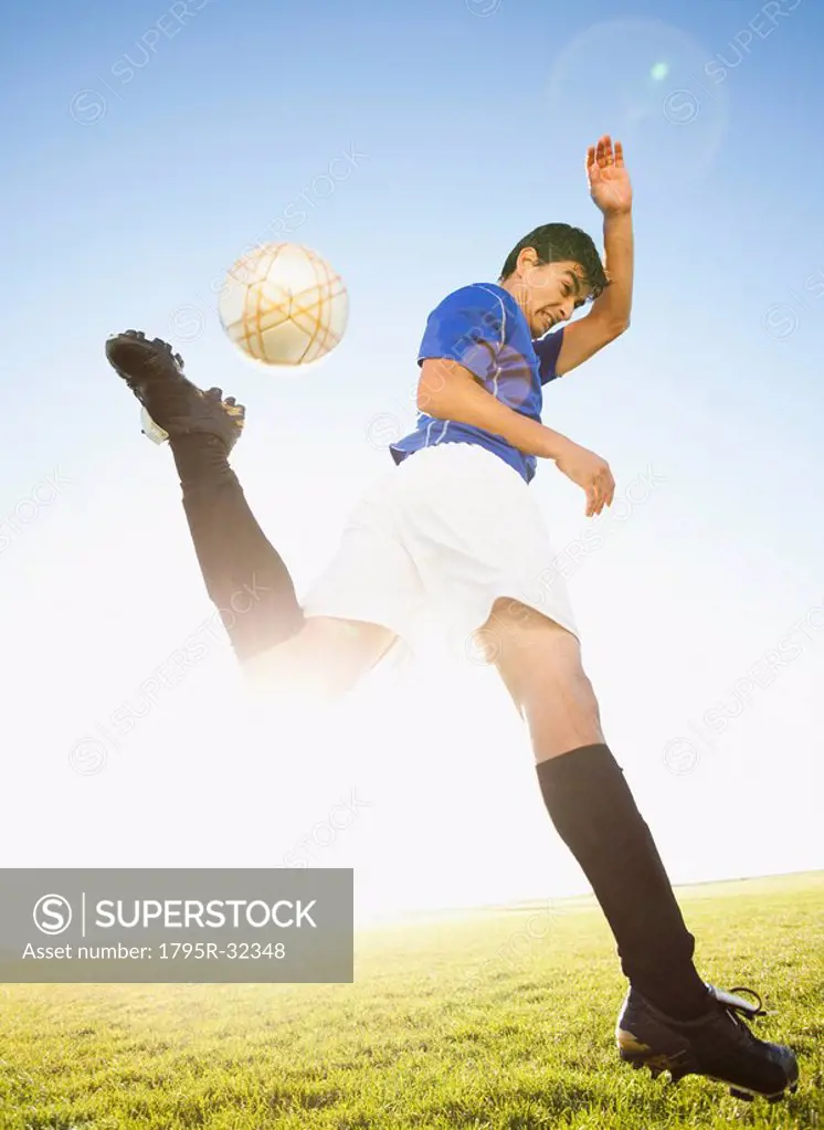 Soccer player jump kicking