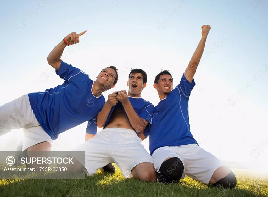 Three happy soccer players
