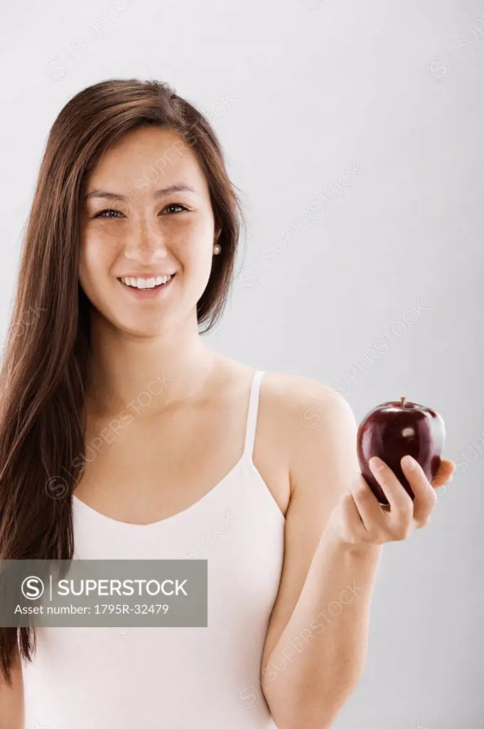 Woman holding a red apple