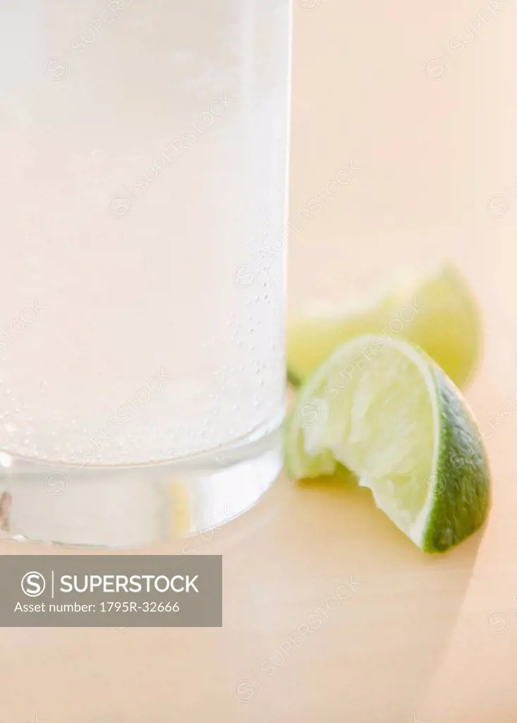 Slices of lime beside glass of water