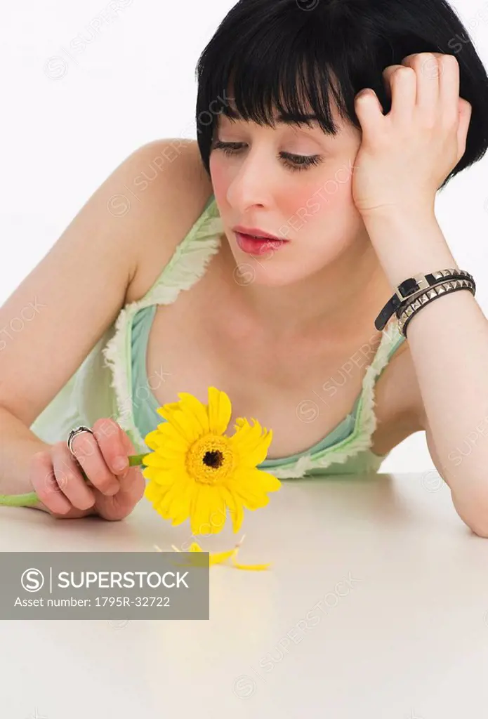 Sad woman holding a flower