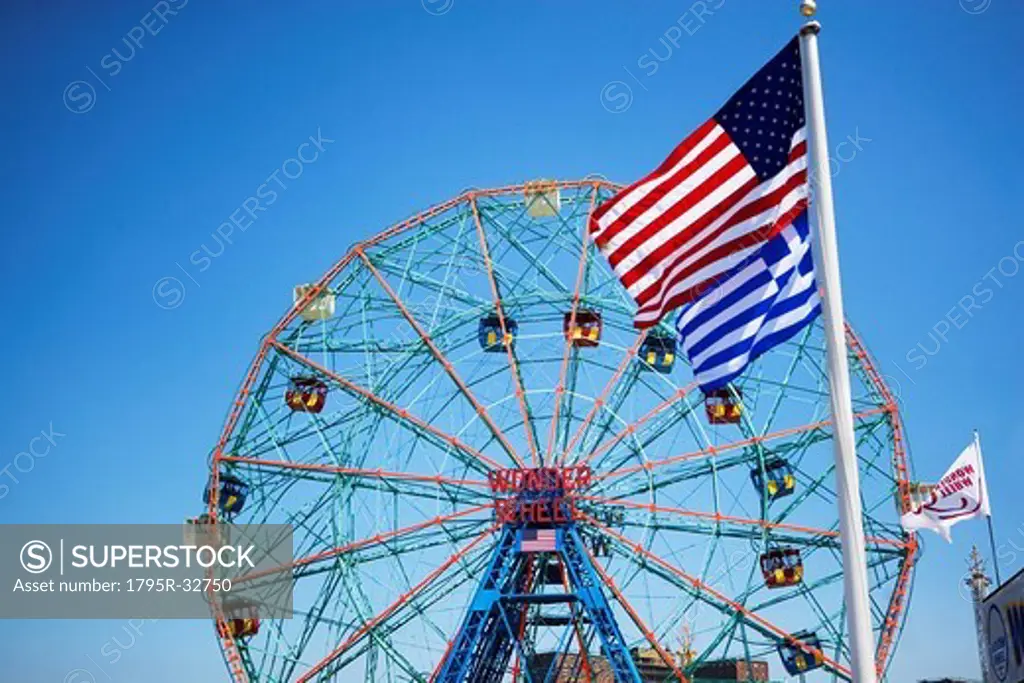 Flags in front of Ferris wheel