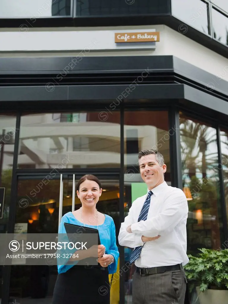 Business owners standing in front of building