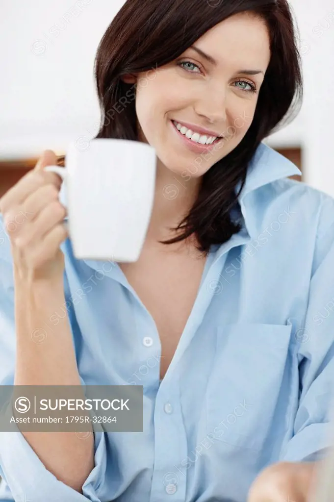 Brunette woman drinking coffee