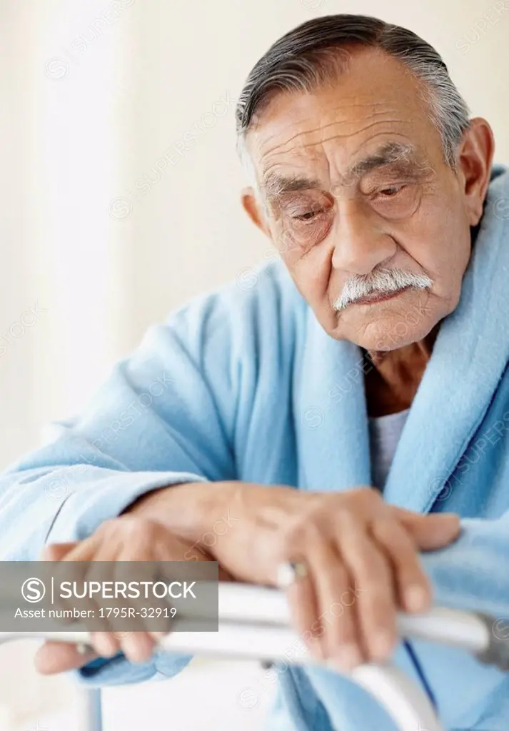 Elderly patient leaning on a walker
