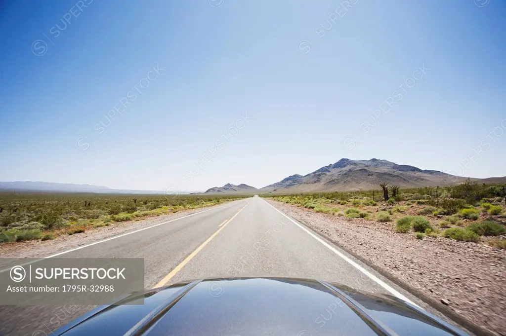 Car driving on highway through the desert