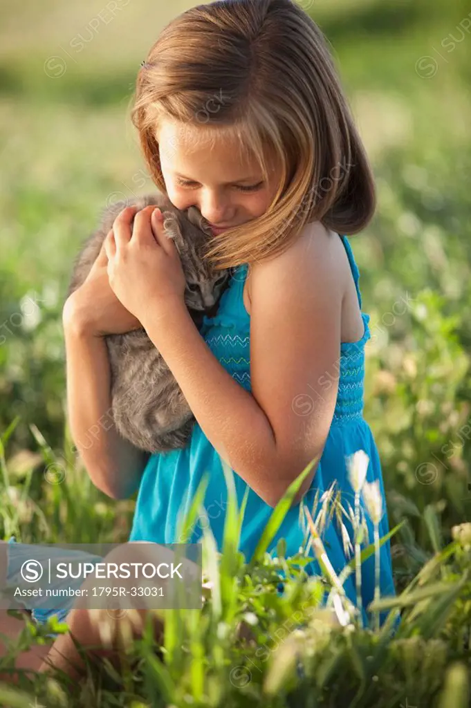 Young girl holding a kitten