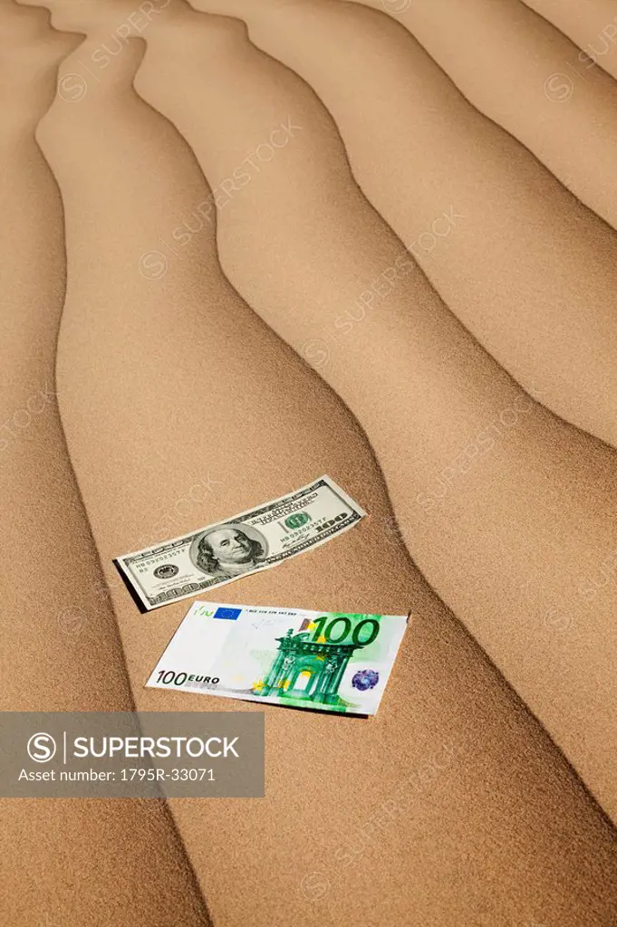 Money on sand in desert