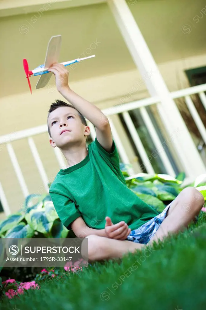 Young boy playing with toy airplane