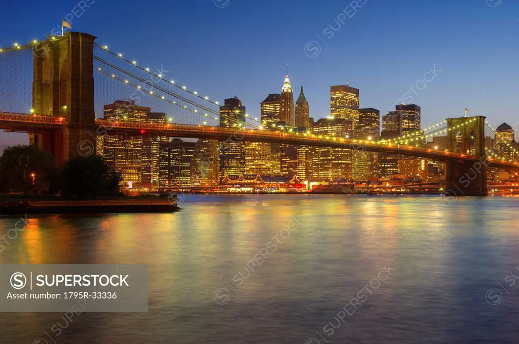 Brooklyn Bridge and Jersey City buildings at night
