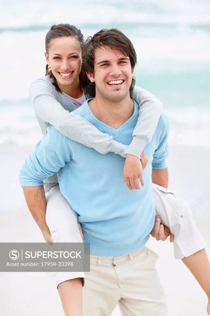 Man giving woman a piggy back ride