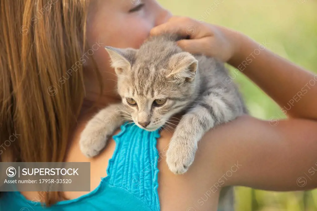 Young girl holding a kitten
