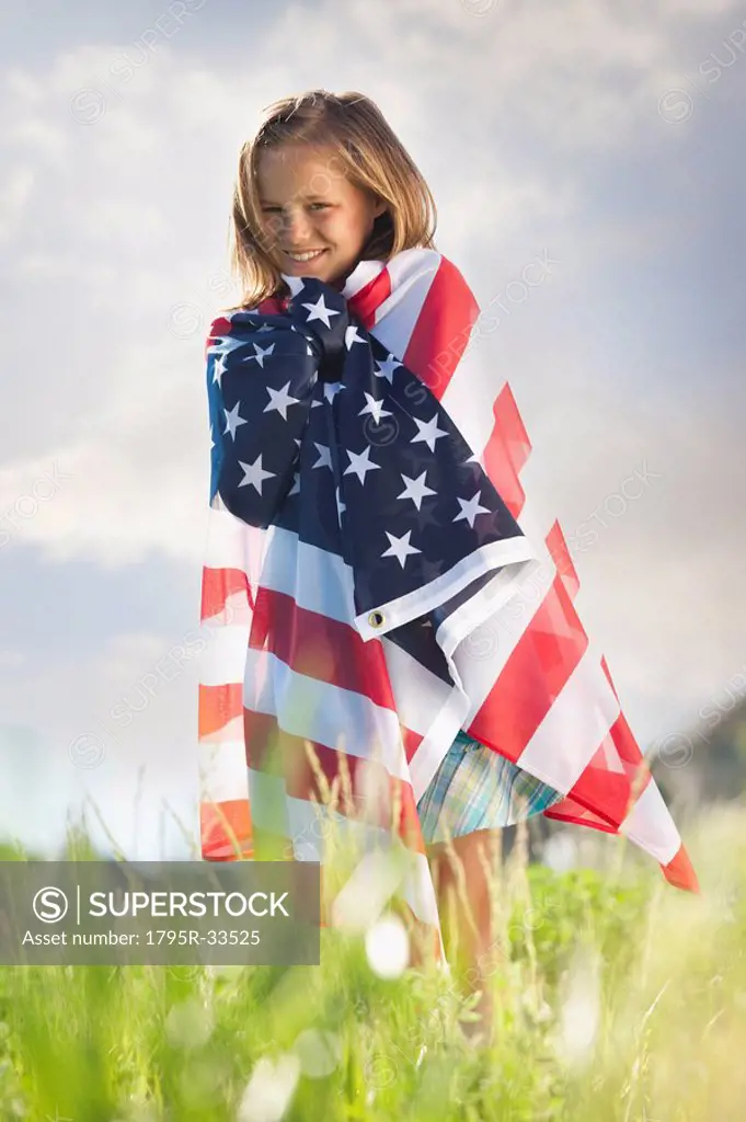Young girl draped in American flag