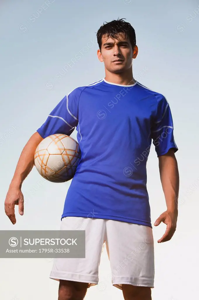 Soccer player holding ball